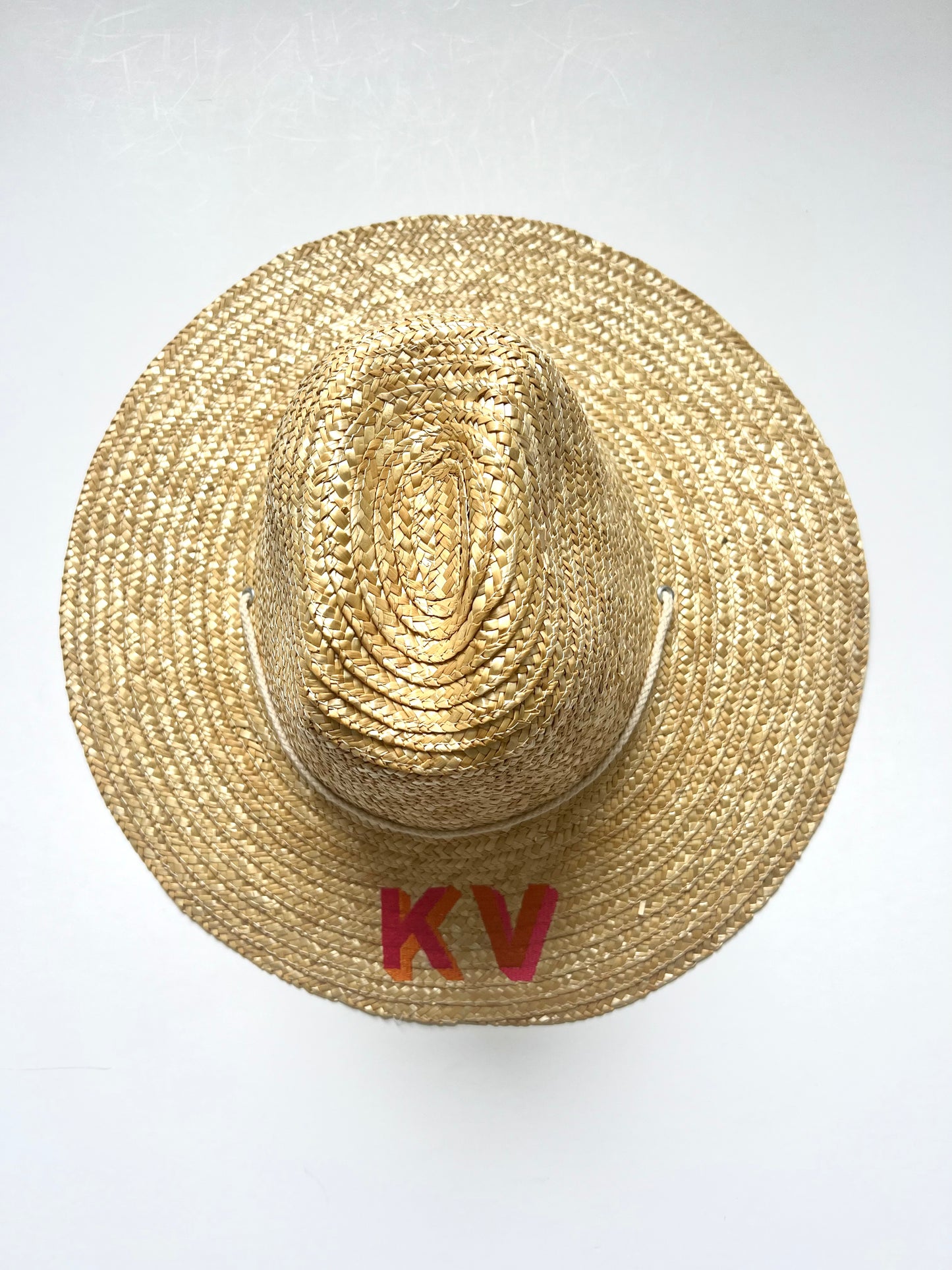Kat font with orange and tropical pink thread inverse.