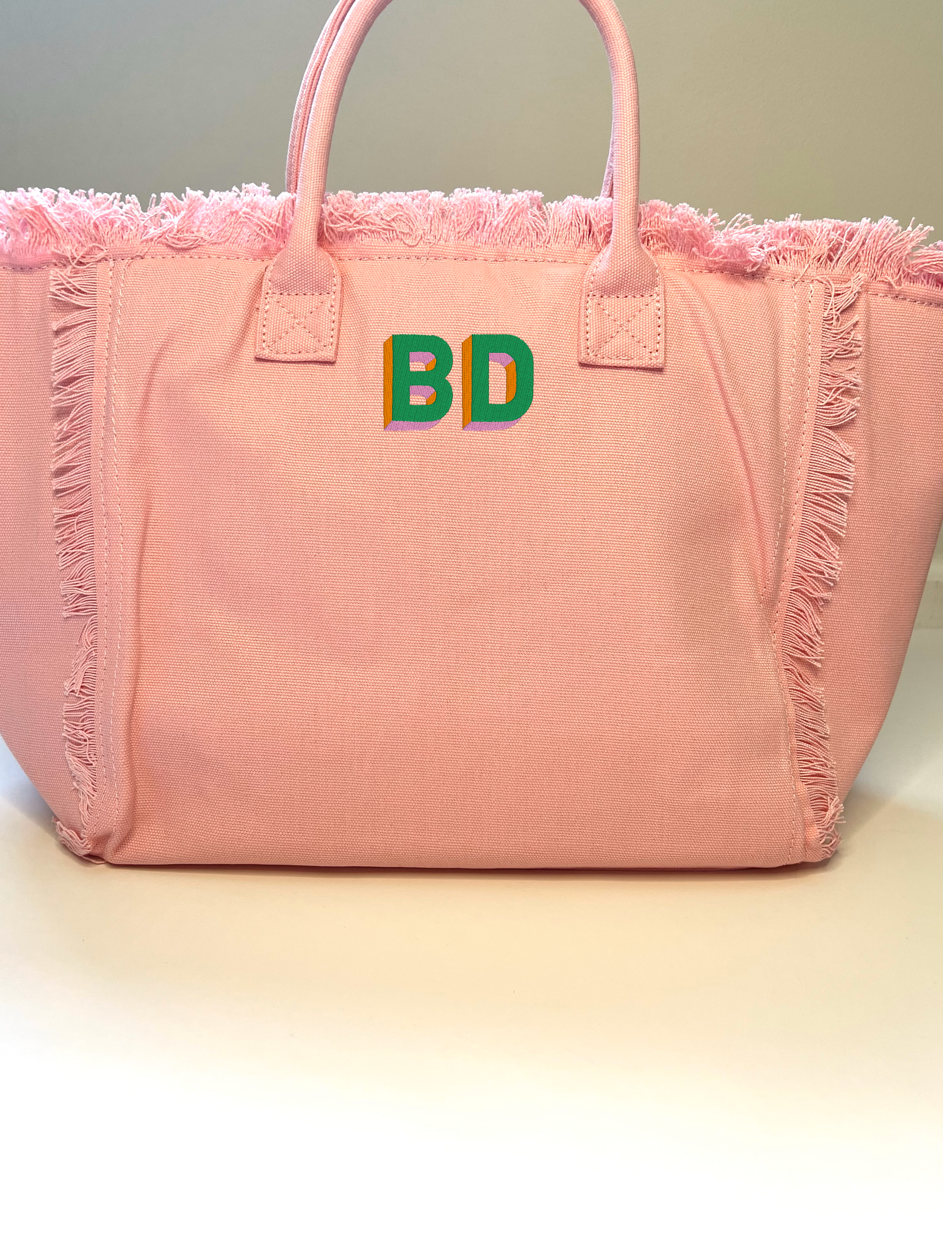 QT font with kelly green, orange and pink thread