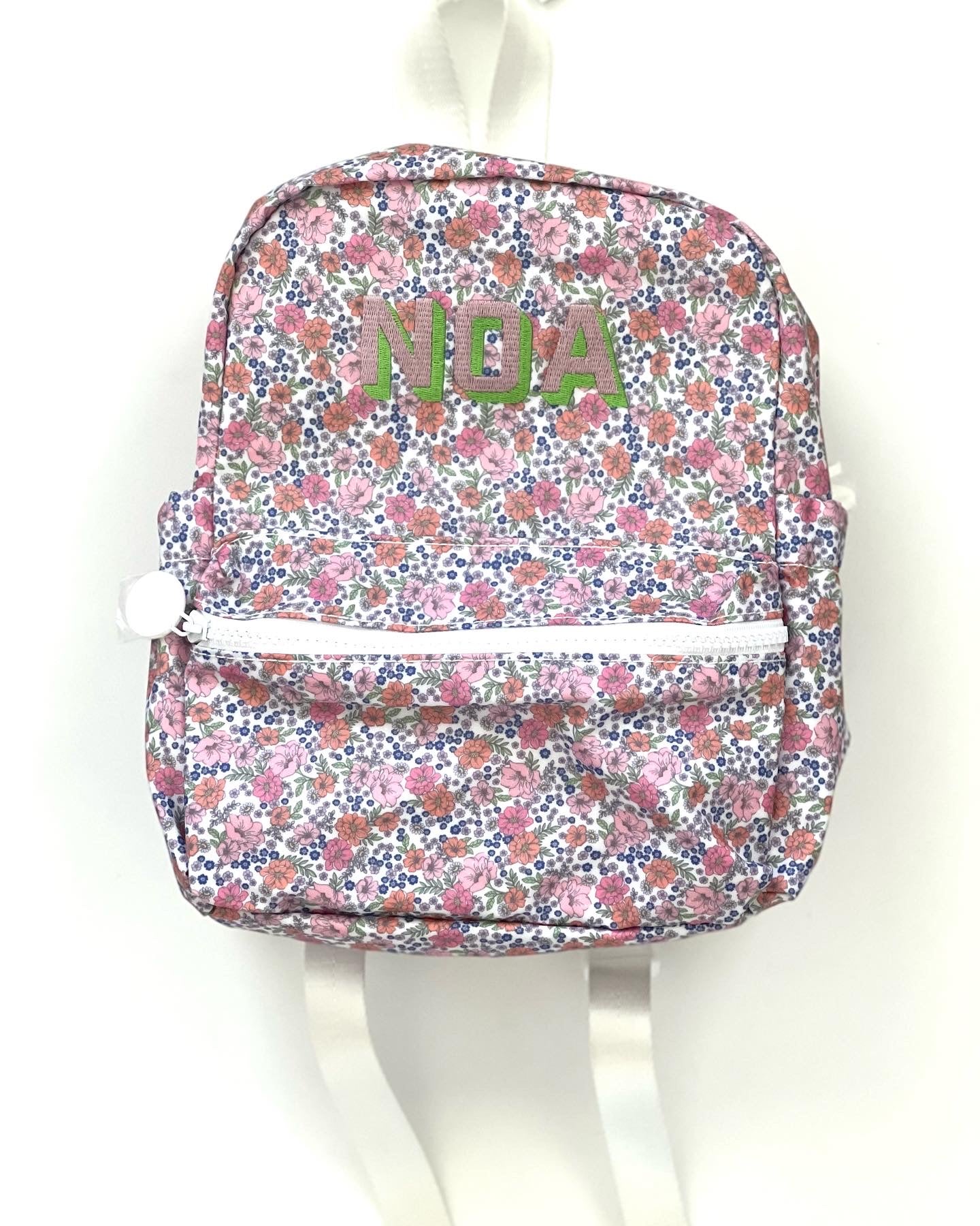 Kat font with bright mint and shell pink thread